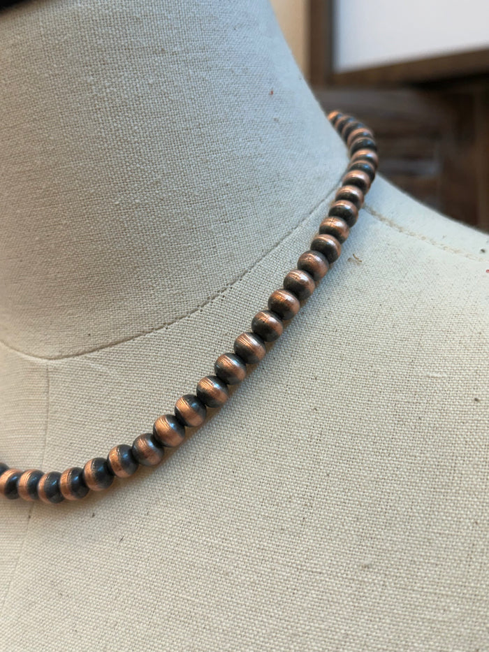 Close-up of 8mm copper bead necklace with dark bronze and copper tones