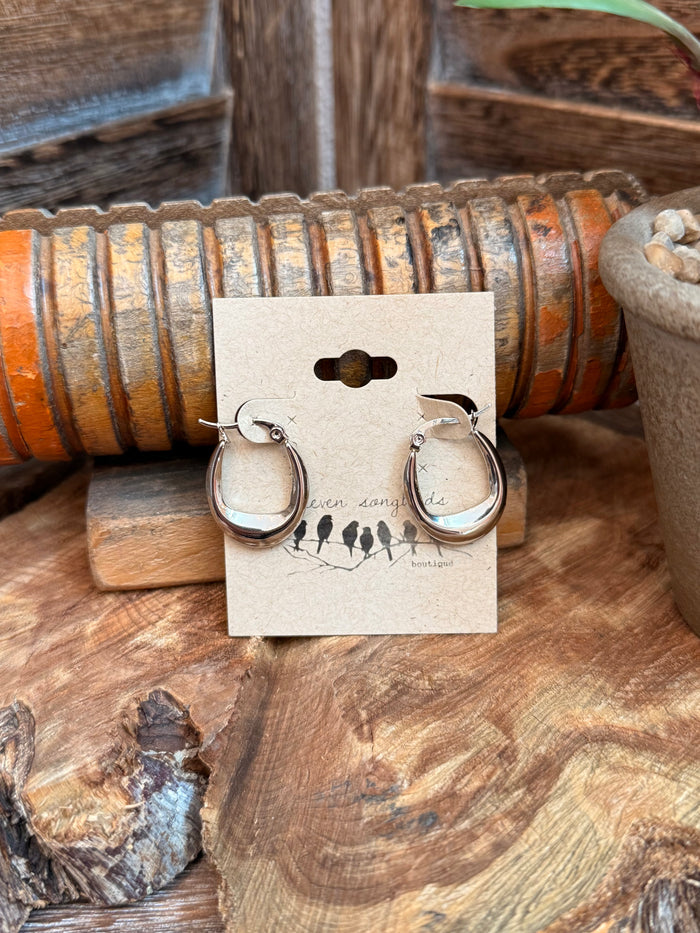 Stainless steel crescent stud earrings, silver-tone, round hoop shape with small cross detail