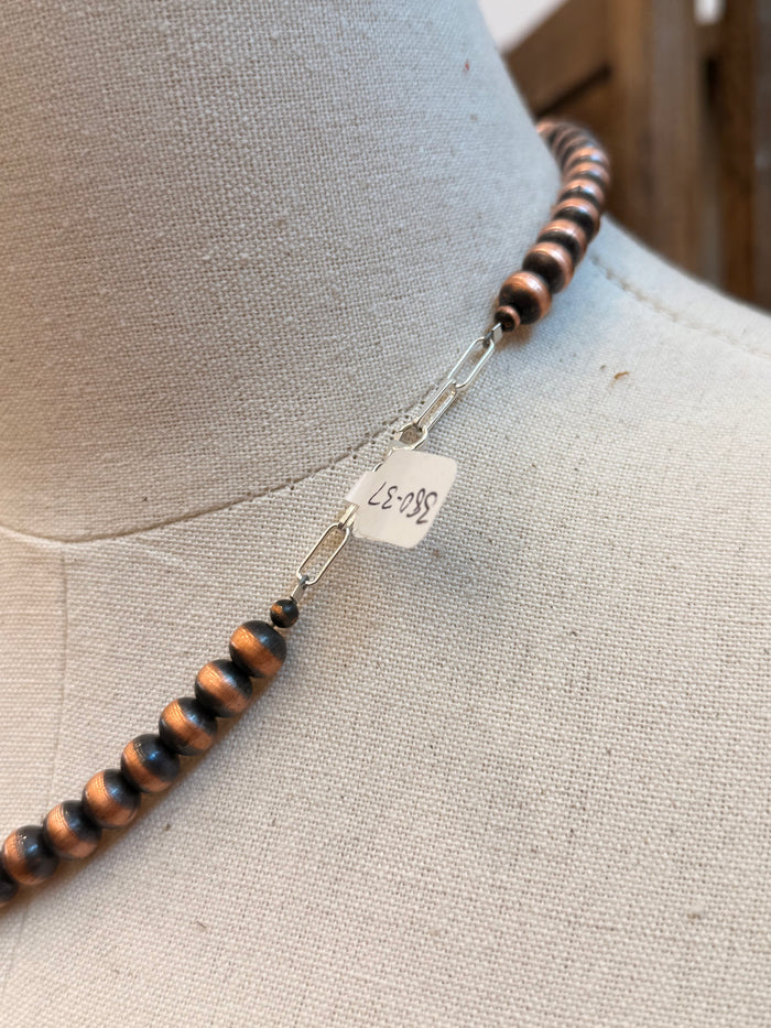 Copper bead necklace clasp with stamped metal tag and small hook closure