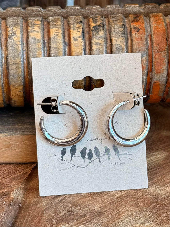 Silver stainless steel round hoop stud earrings with circular hoops, front view.