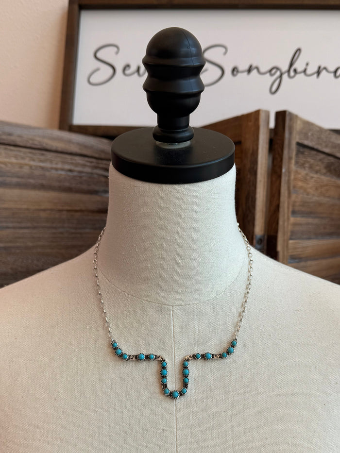Longhorn outline necklace featuring a turquoise bead pendant on fine chain