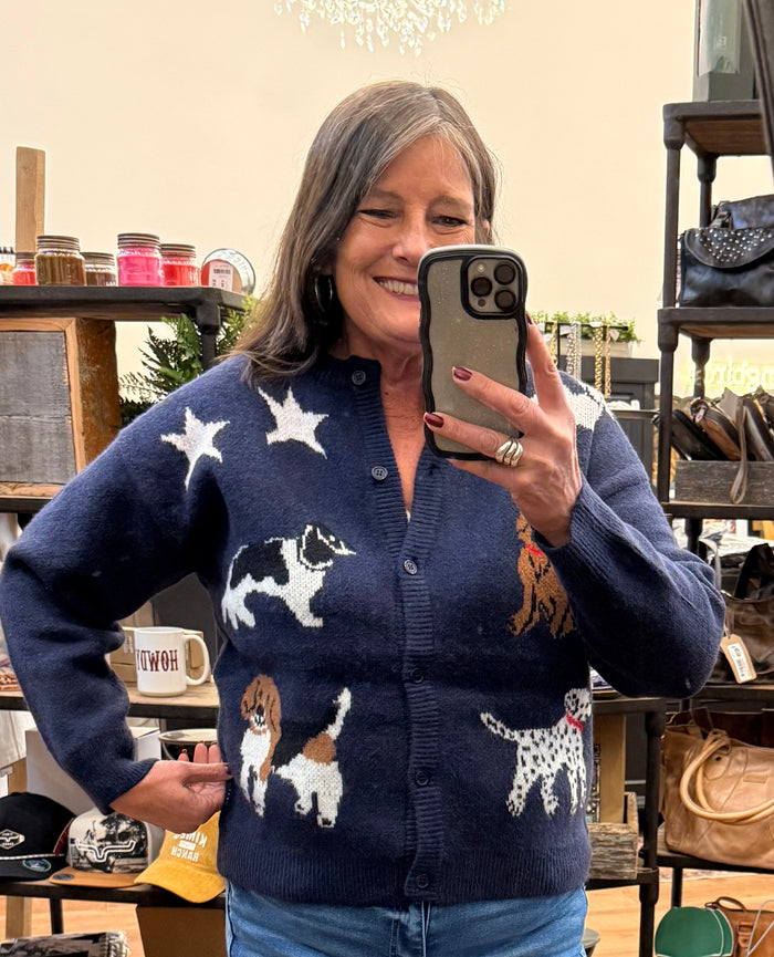 Navy dog-print button-up cardigan sweater featuring multiple knitted dogs and stars