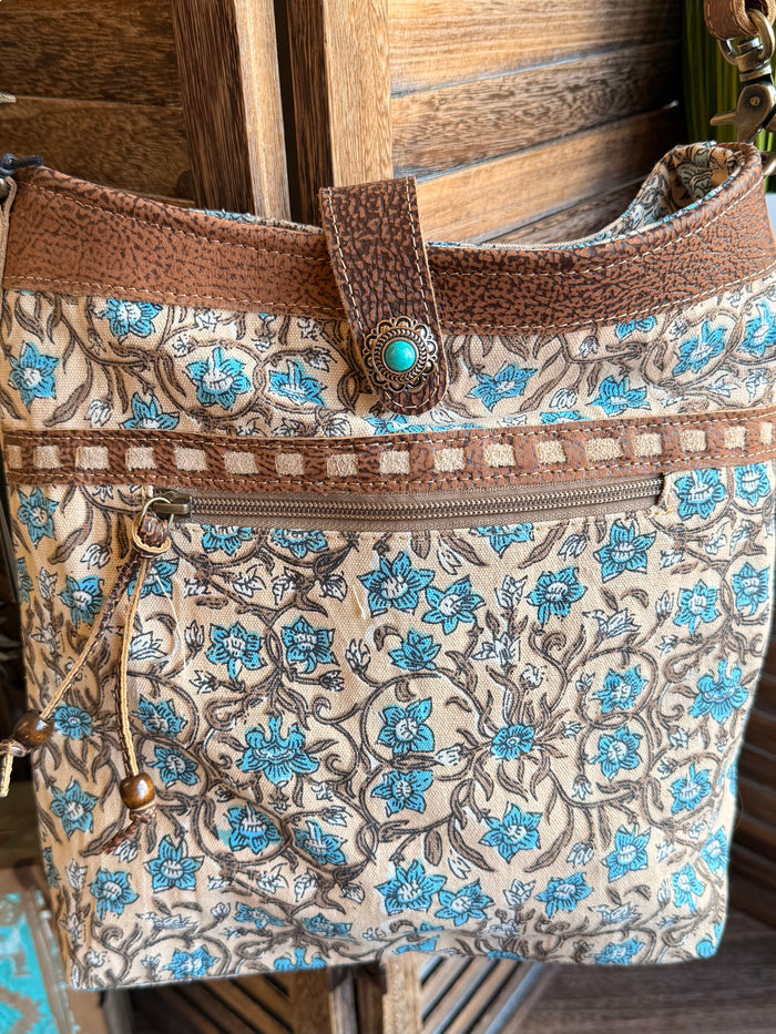 Blue and tan floral canvas tote with brown top band, turquoise snap button