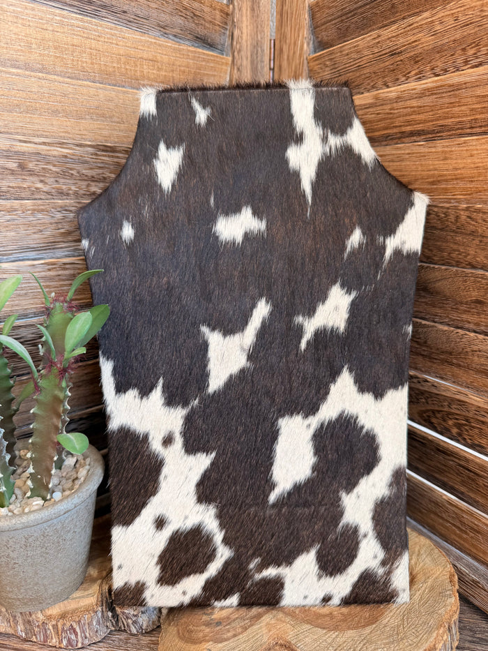 Cowhide necklace easel display in dark cowhide with scattered white spots