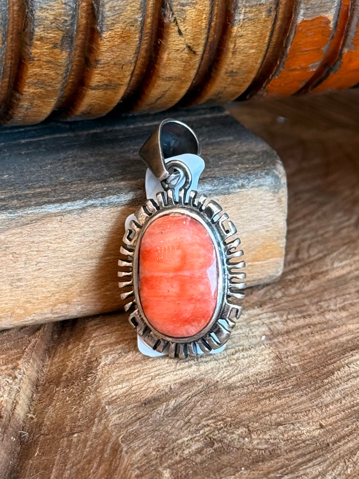 Small vintage pendant, oval orange cabochon stone in silver-tone spiny frame