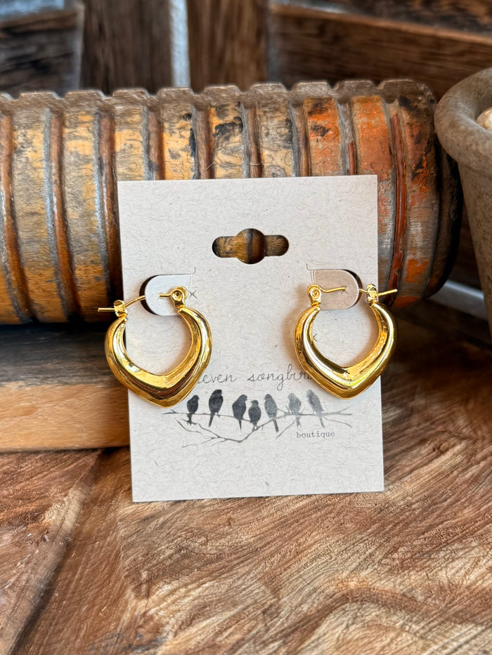 Gold-tone half-hoop earrings with heart-like detail and hinged closure