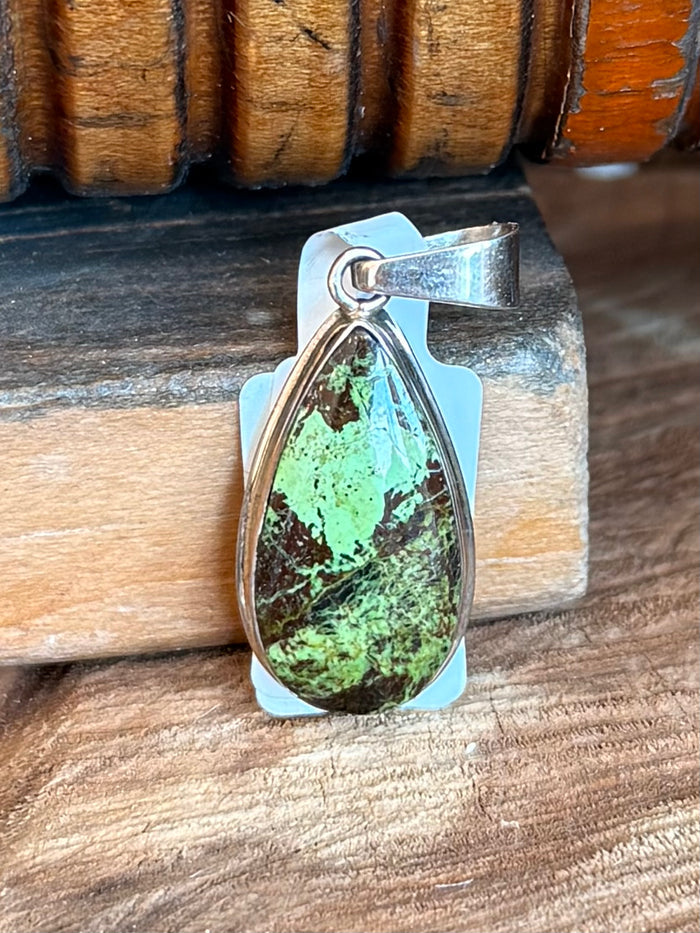 Silver teardrop pendant with bright green Gaspeite center stone, open frame