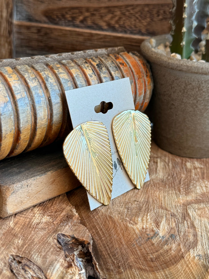 Gold ribbed leaf stud earrings with curved leaf texture, visible post and pair