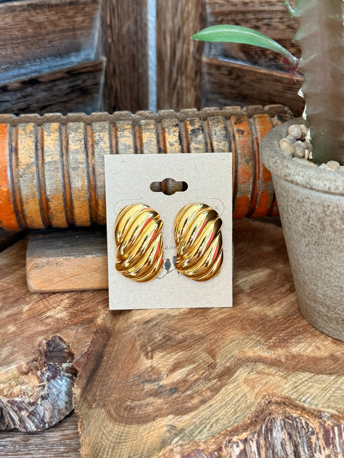 Gold-plated textured oval stud earrings on display card, pair