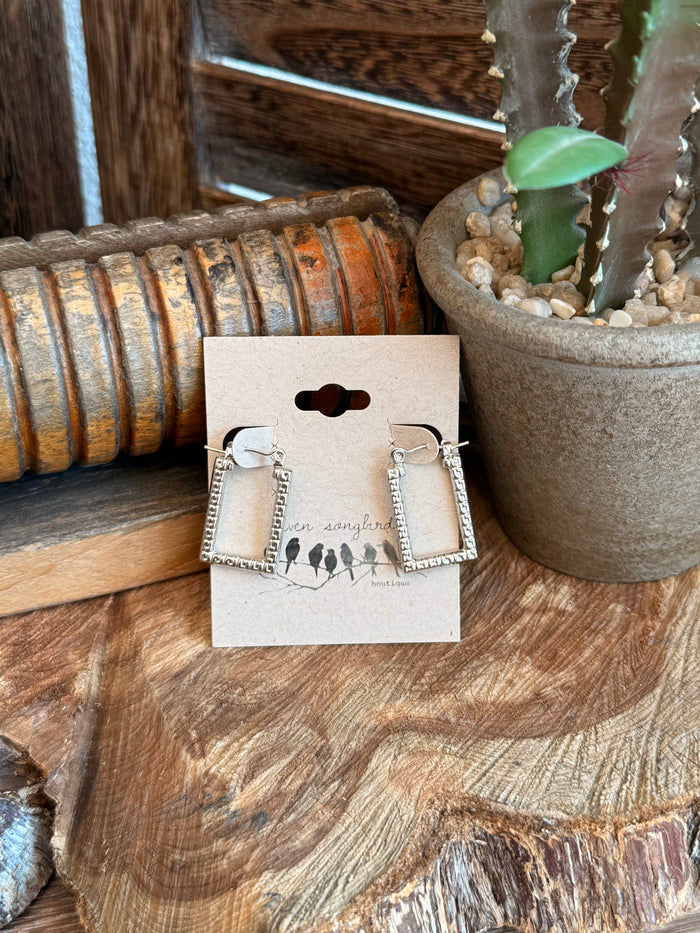 Silver textured trapezoid stud earrings with rectangular frames, set on small post backs.