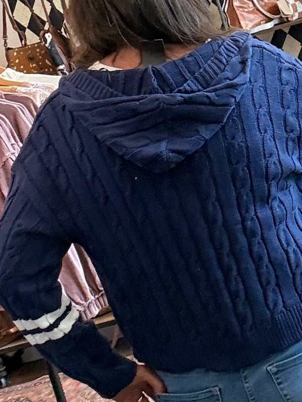 Navy cable-knit hooded cardigan back with textured cable pattern and ribbed trim