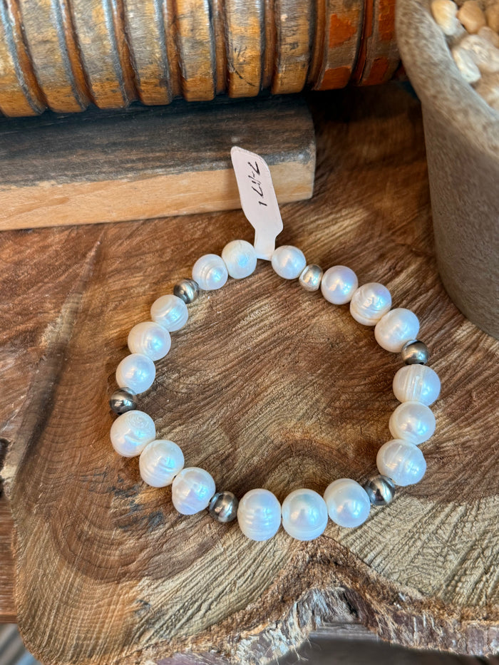 Stretchy freshwater pearl bracelet with opalescent white beads and dark metal spacers