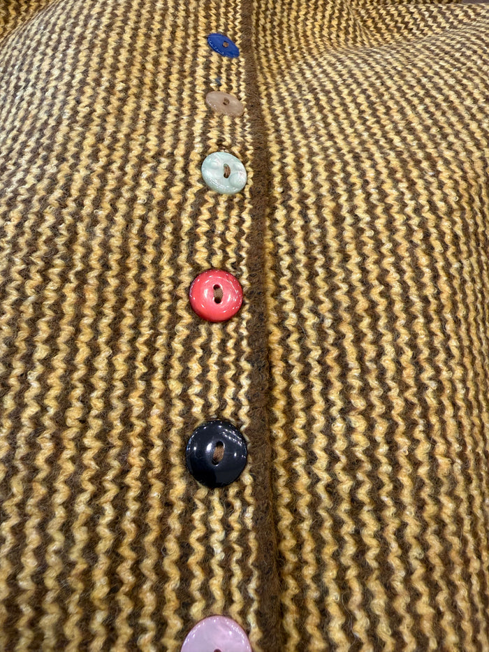 Striped knit cardigan placket with multicolor round buttons close-up