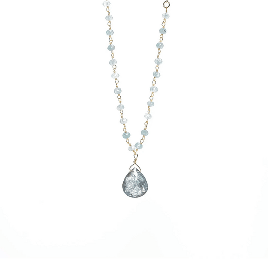 Delicate necklace featuring light blue beads and a teardrop-shaped pendant with a textured surface, designed as the Alice Rosary Necklace | Liv & B.