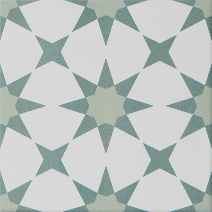 Geometric pattern tile with white and green shapes on a white background