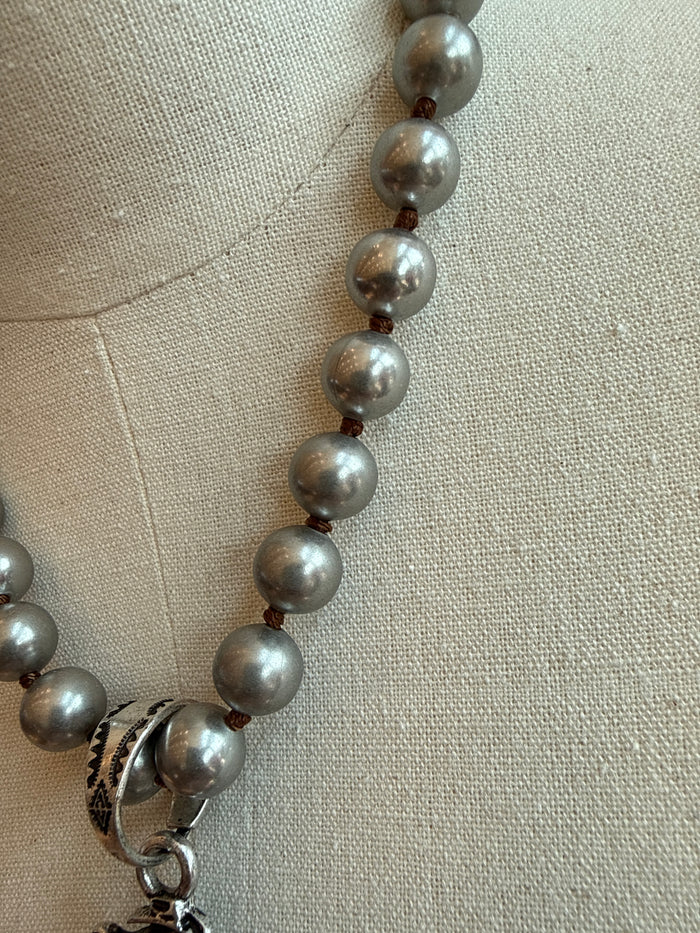 Silver-tone pearl-like bead necklace with clasp and ring detail