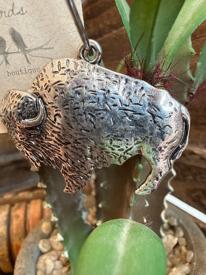 Silver-tone buffalo drop earring with textured face and metal loop