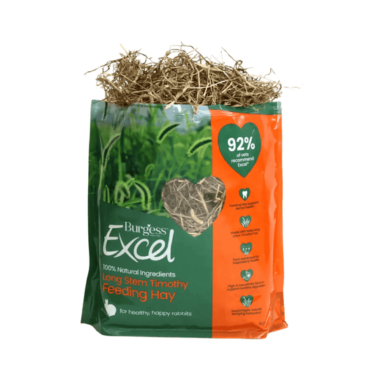 White background with a bag of Burgess Long Stem Timothy Feeding Hay. The bag is dark green and orange with a heart shape window showing the hay inside. Text on the bag reads 'Burgess Excel, Long Stem Timothy Feeding Hay.'