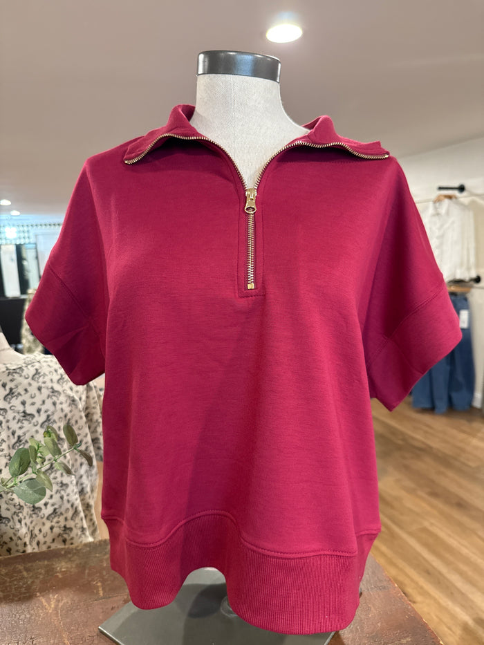 Burgundy quarter-zip T-shirt with short sleeves and gold-tone half zipper