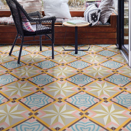 Patterned floor tiles in a geometric design with a chair and table in the background.