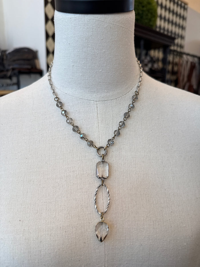 Silver-tone crystal beaded necklace with three dangling teardrop charms