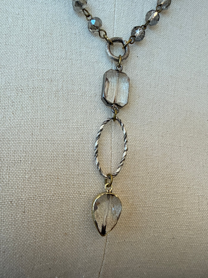 Silver-tone crystal beaded necklace close-up with three faceted drop charms