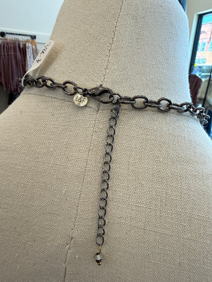 Silver-tone chain necklace with adjustable extender and small dangling bead.