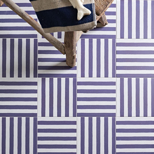 Blue and white striped tiles laid in a basketweave pattern.