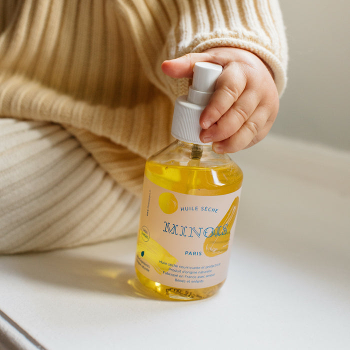 Minois Dry Oil in childs hand.