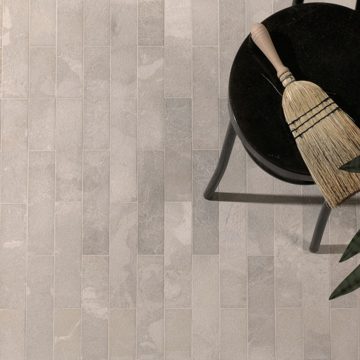 Limestone parquet floor with a broom and chair