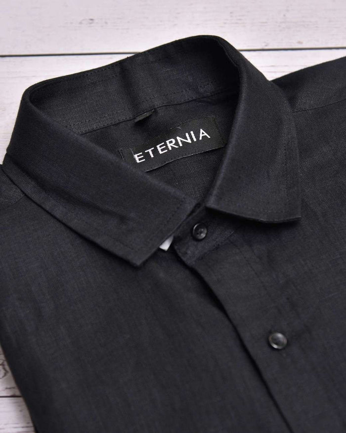 Black men's linen shirt close-up: spread collar, button placket, ETERNIA logo