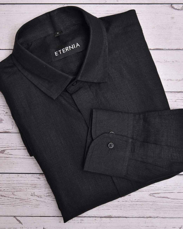 Black men's linen shirt with long sleeves, button cuffs, and chest pocket
