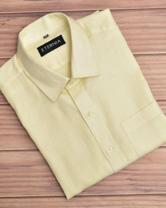 Men's butter yellow linen shirt with button-front and pointed collar, folded flat.