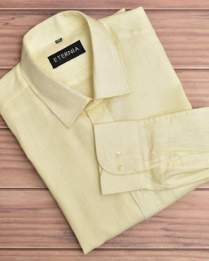 Men's butter yellow linen shirt with button placket and open cuffs, laid flat.