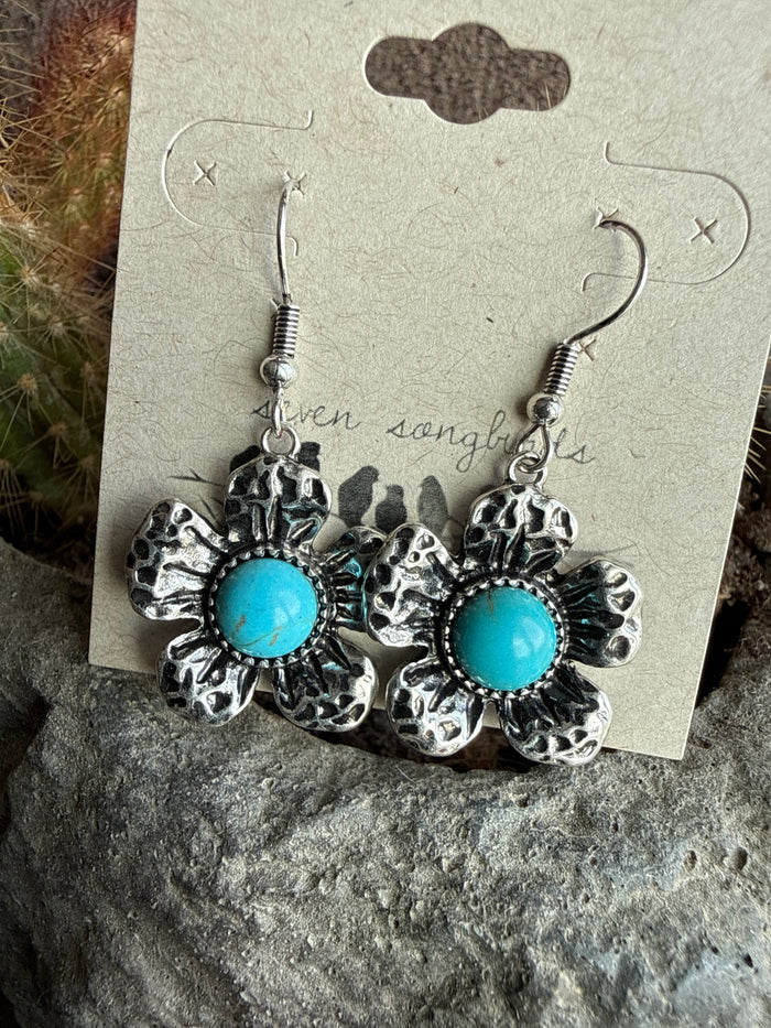 Turquoise flower fishhook earrings with silver textured petals and round cabochon drops