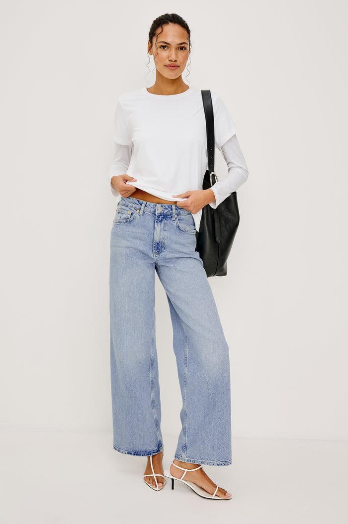 Getty Wide Leg Jean in Light Stretch Denim With High-Rise High-Waisted Fit, Button Fly, and 5-Pocket Styling in Jasper Colorway - Full Body Front View Featured on Model