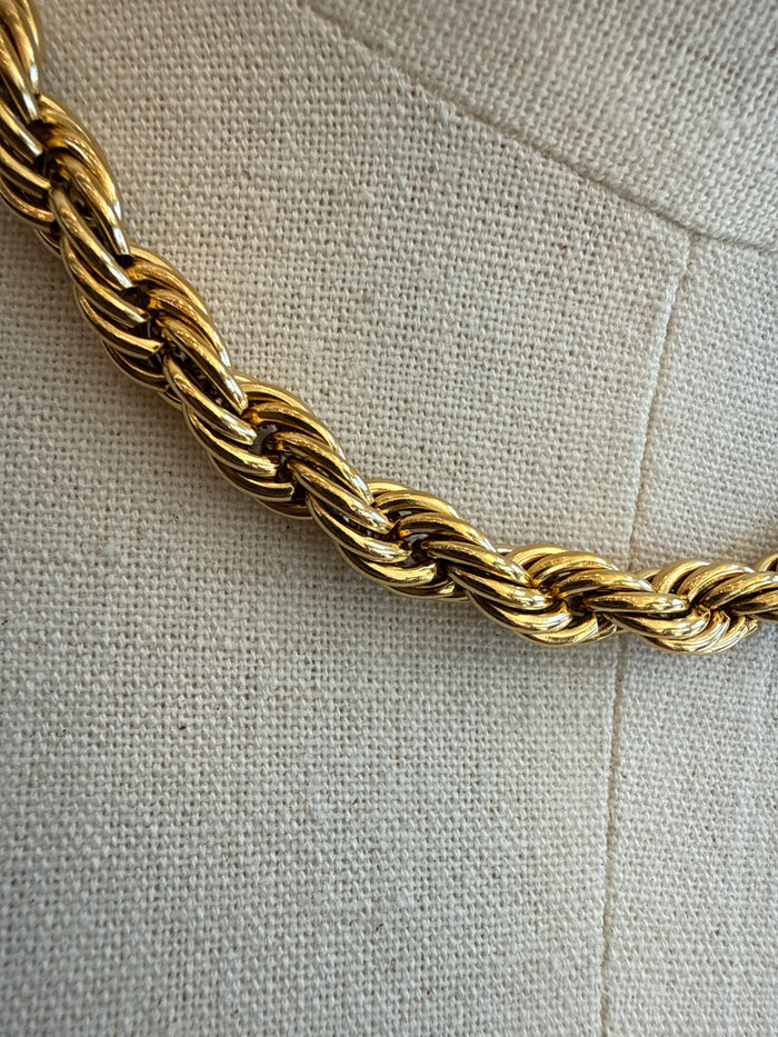 Close-up of gold-plated thick chain necklace with twisted oval links