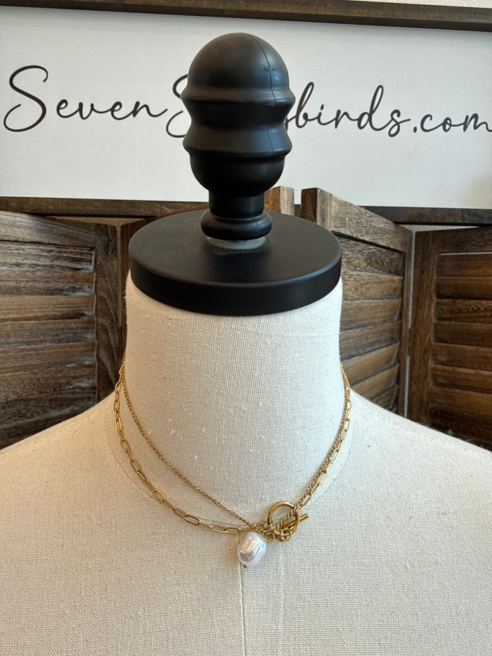 Gold-tone toggle clasp necklace with single white pearl on fine chain