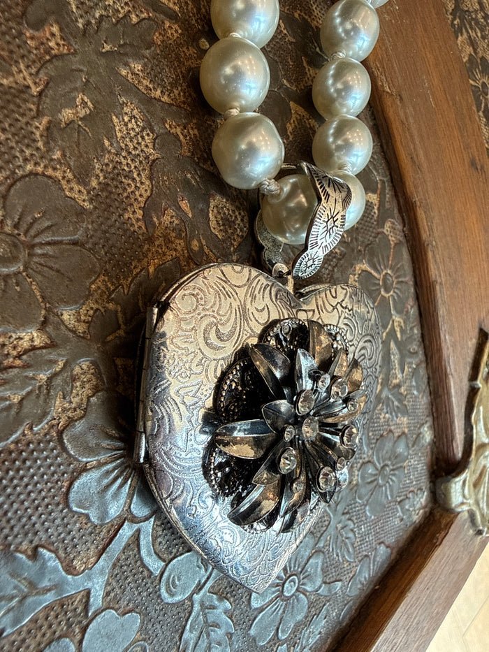 Heart locket pendant necklace with white pearl beads and black-floral heart centerpiece