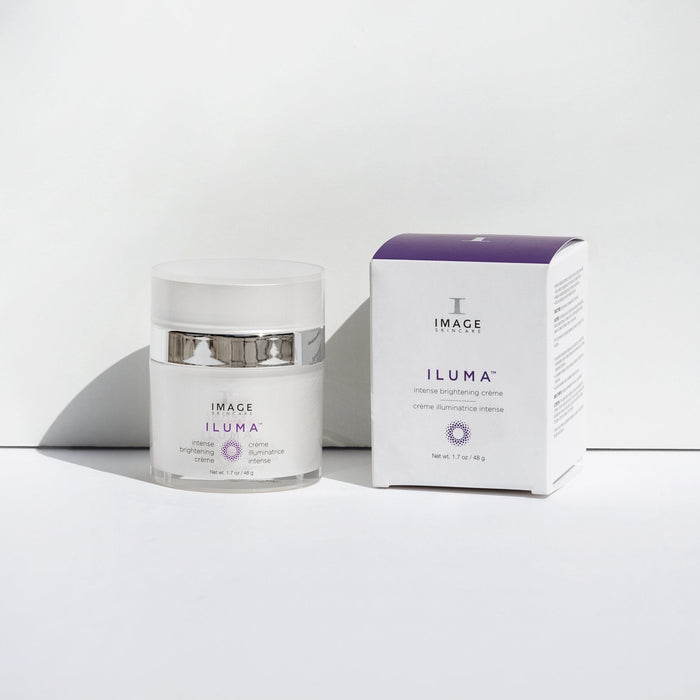 ILUMA intense brightening crème | IMAGE Skincare in a white jar with silver accents next to its white and purple retail box, displayed on a clean white surface for skincare and wellness supplements.