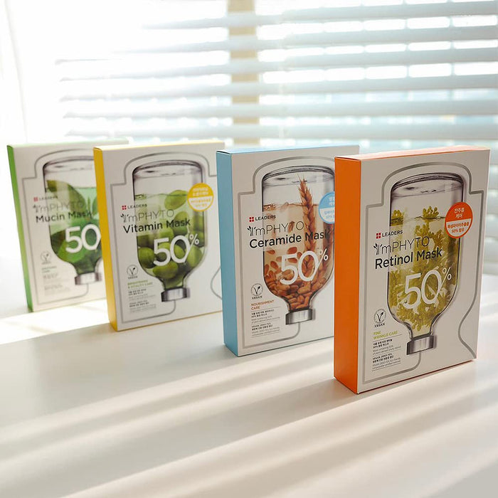 Four skincare mask boxes with vibrant green, yellow, blue, and orange accents arranged in a row on a white surface, featuring the product ImPHYTO Retinol | Leaders on the rightmost box.
