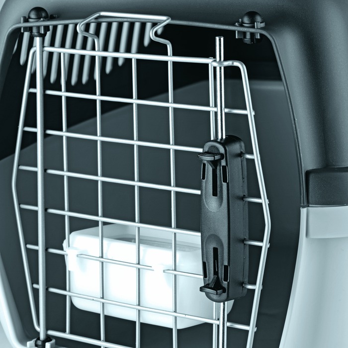 White background with a close up of a Krusse Stefanplast Travel Cage door with a white water bowl clipped on the inside.