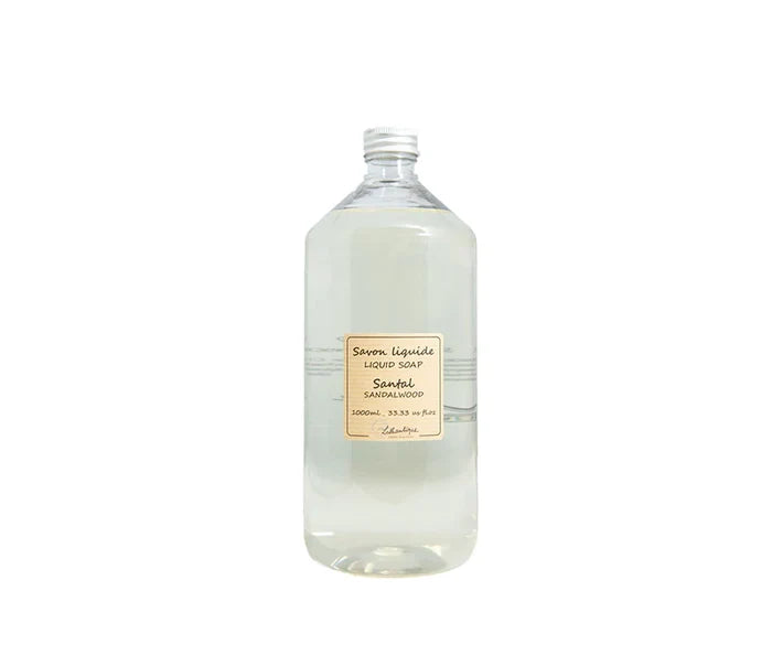 Bottle of liquid soap with a label on a white background