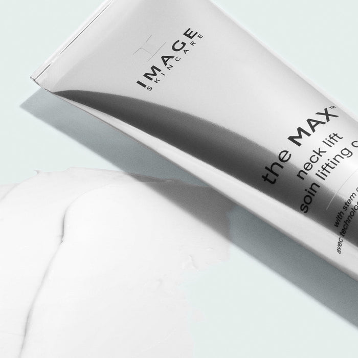Tube of MAX™ neck lift | IMAGE Skincare cream with a smooth white lotion spread beside it on a light surface, highlighting skincare and wellness care.