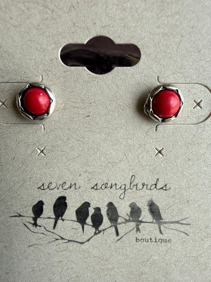 Mini stud earrings with round red stone domes in silver-tone bezels.