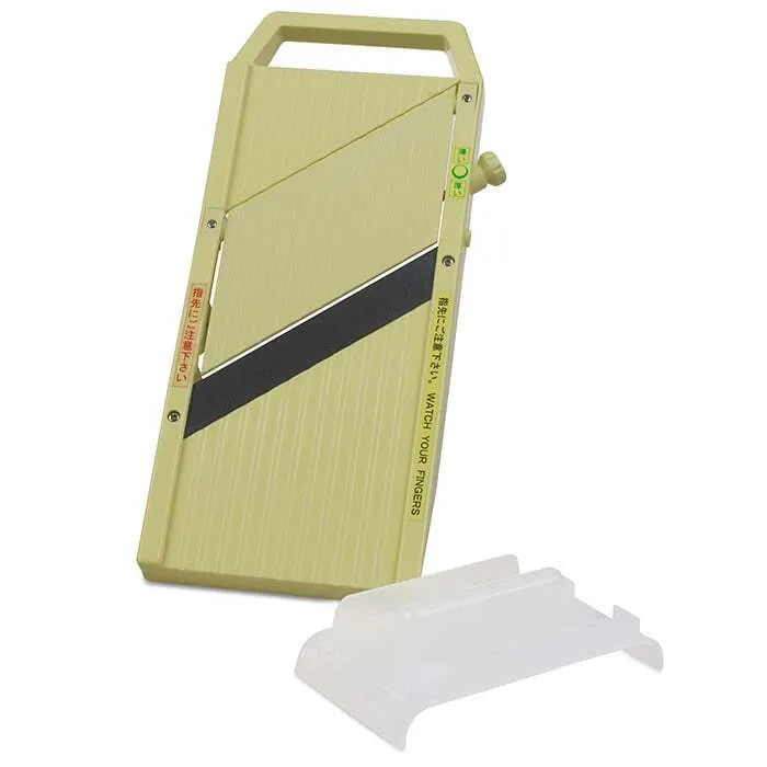 A professional quality mandolin slicer in green color with a silver blade strip, featuring a hand guard and adjustable thickness settings.