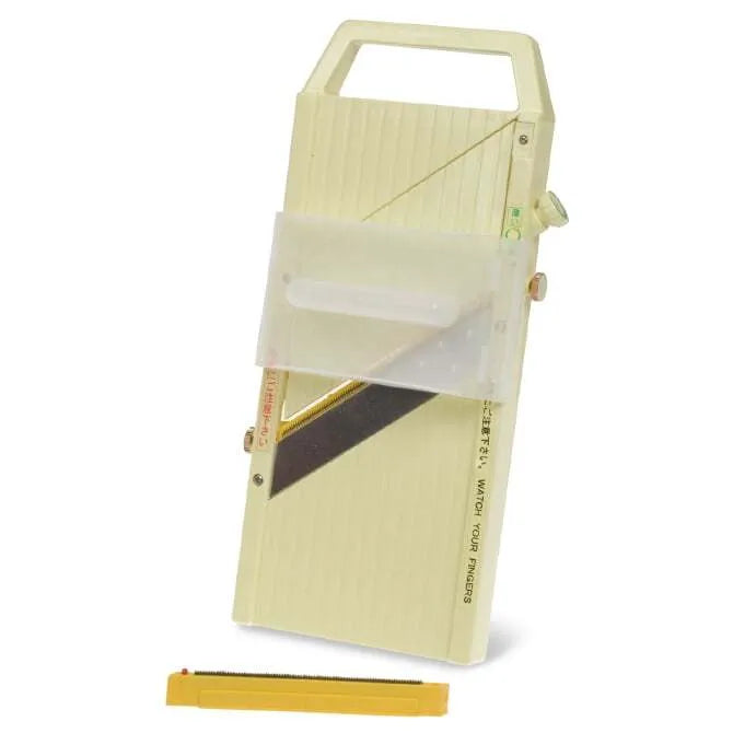 Green mandolin slicer on a white background