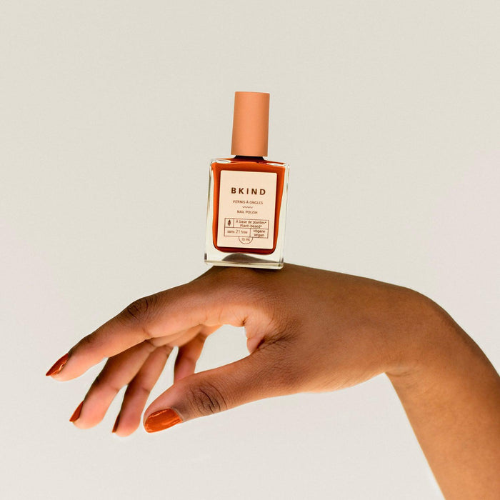 BKIND Bonfire nail polish on hand – warm orange non-toxic manicure in Calgary