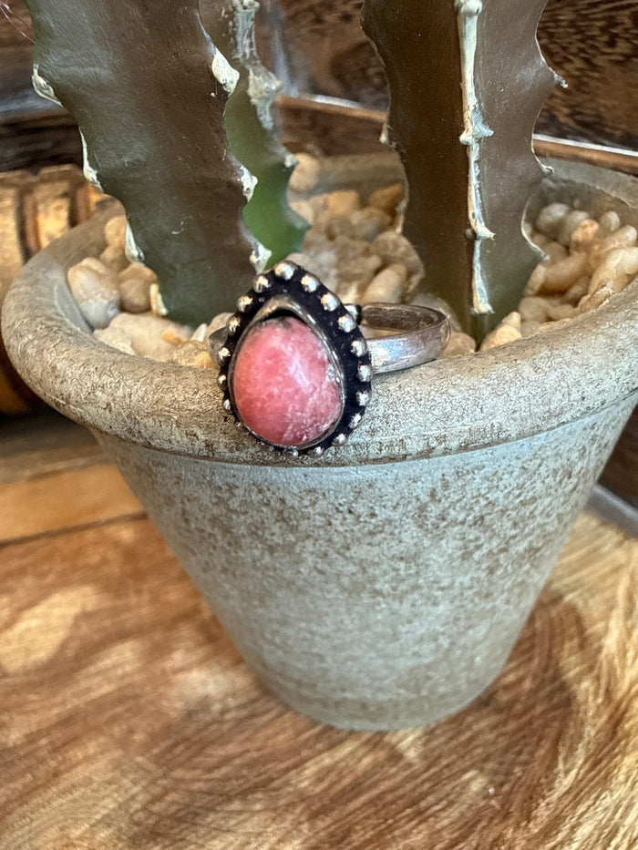 Adjustable brass ring with oval pink/red stone bezel and beaded edge