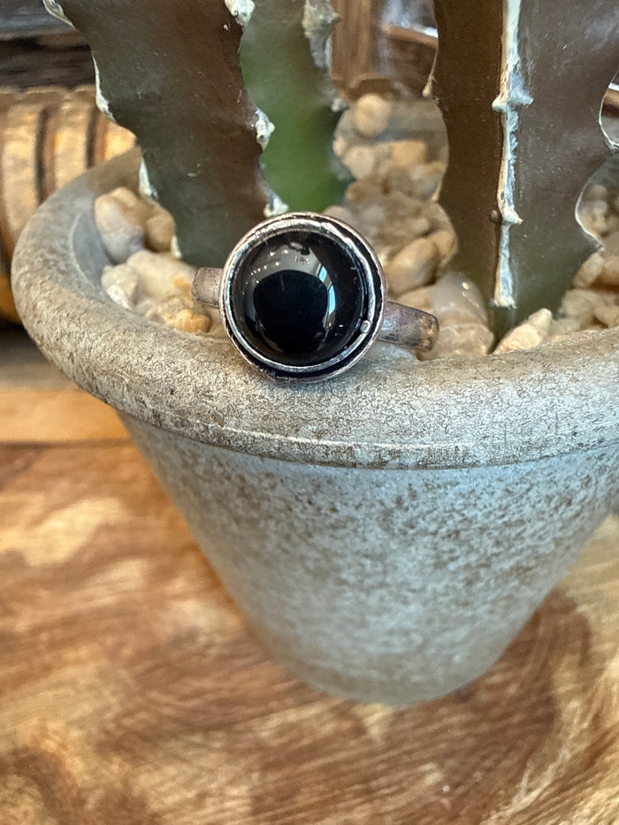 Adjustable brass ring with round black stone bezel and textured silver-toned rim